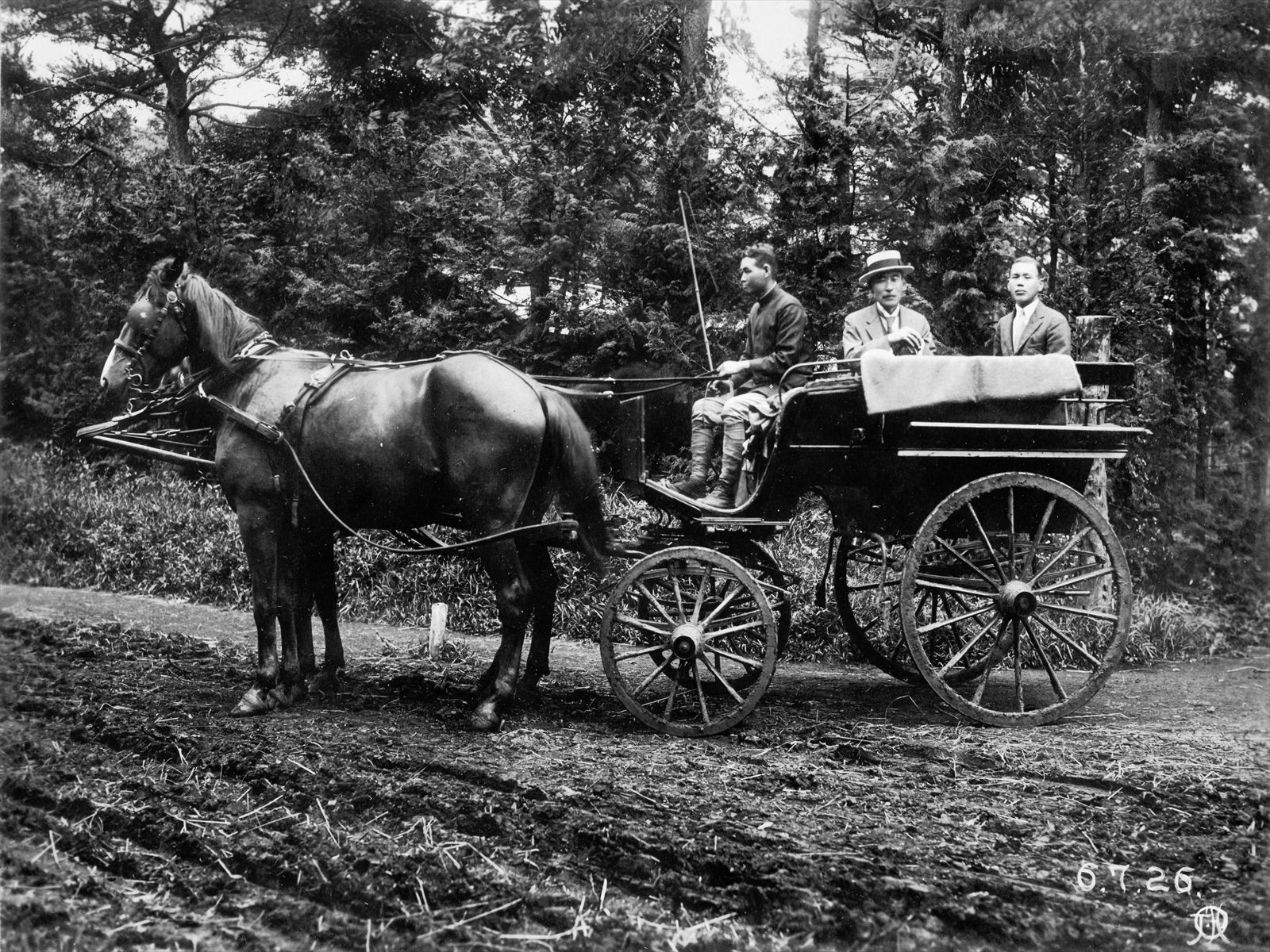 Hisaya and Tachibana, the Farm Manager, riding a horse-drawn carriage
                                            (photo courtesy of the Tachibana Family)